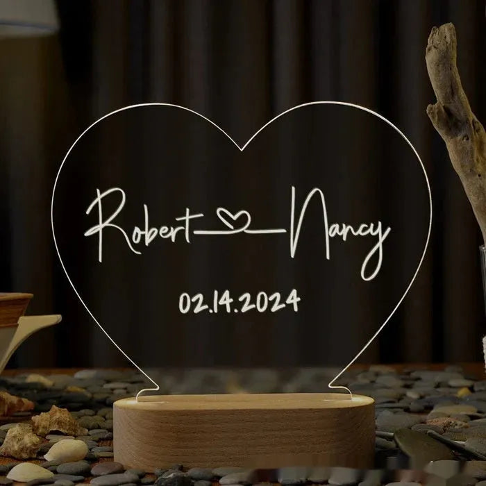 Custom transparent acrylic night light engraved with personal names and a date.