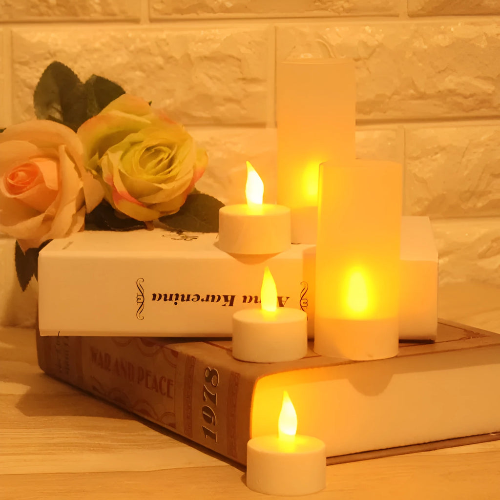 White plastic rechargeable LED candle lamp with yellow glowing flame on a table.
