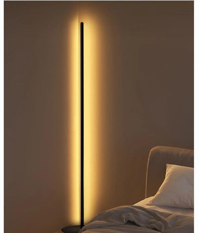 Vertical aluminium alloy floor lamp in modern simplicity style on a table.