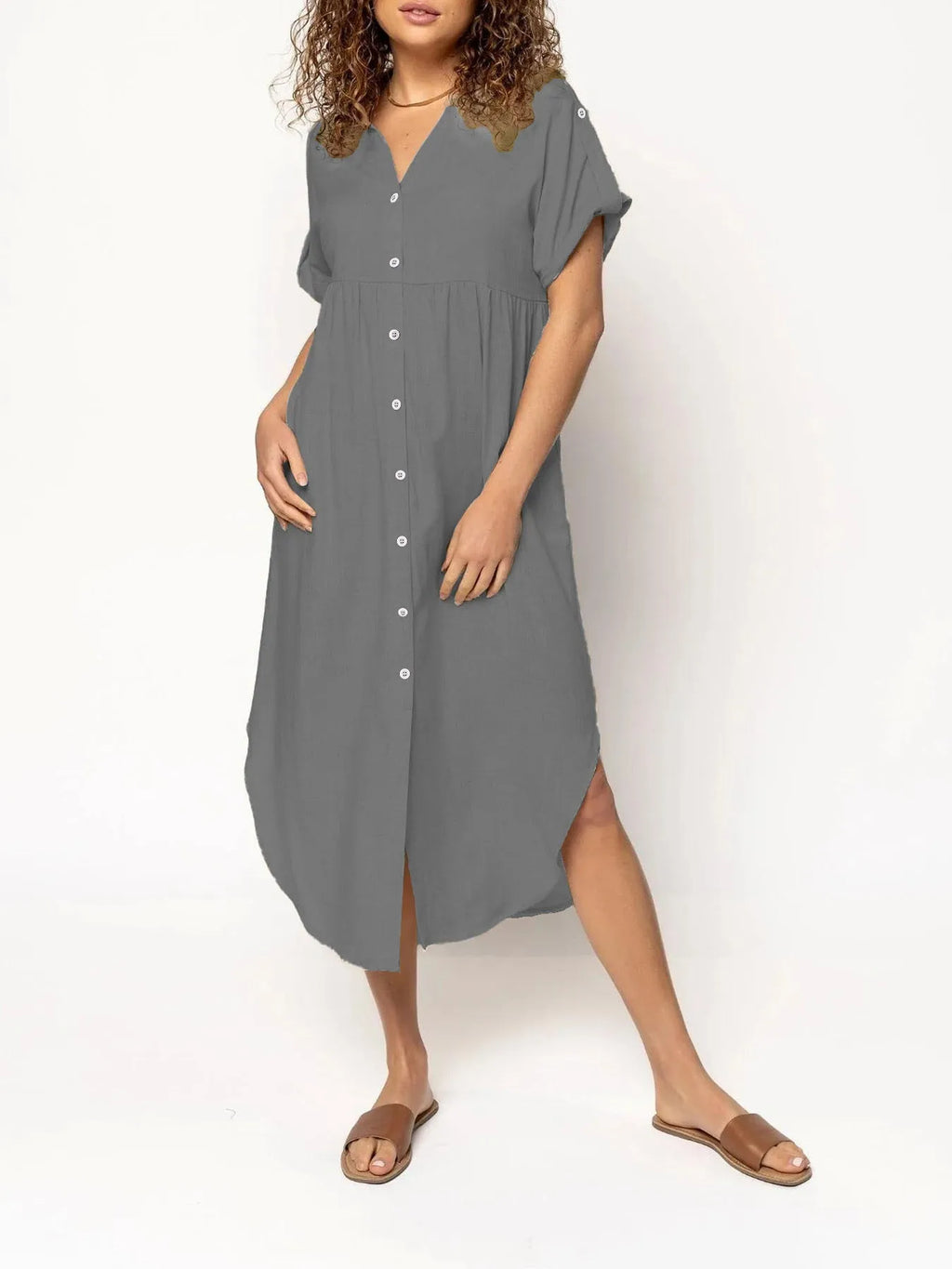 A loose fit, solid colour midi dress with a button front detail, shown in one of eight available colour options.