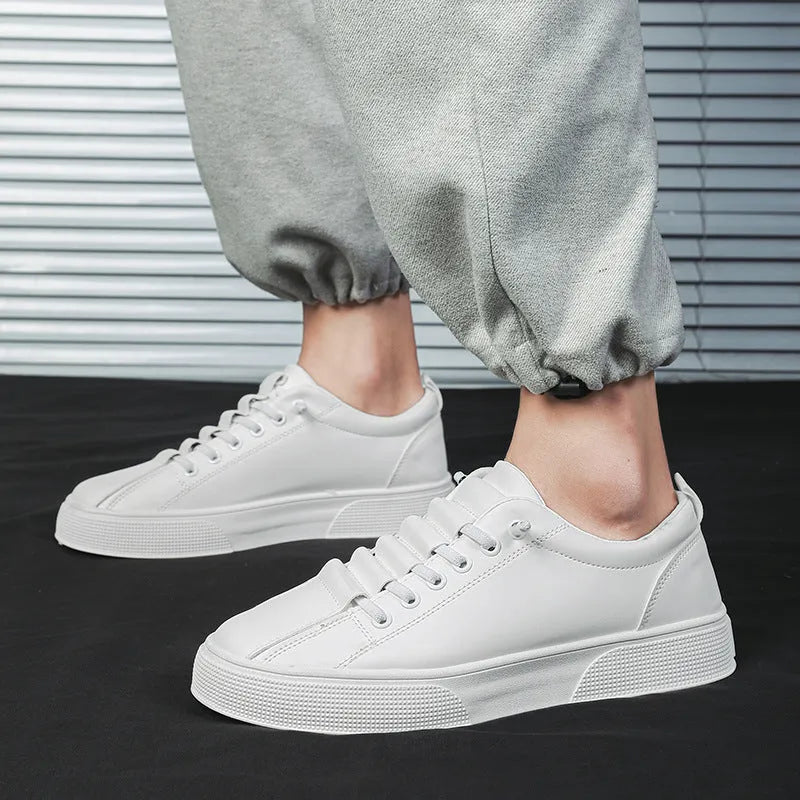 Men's black and white low top sports shoes with mesh panels and synthetic leather upper on a flat PVC sole.