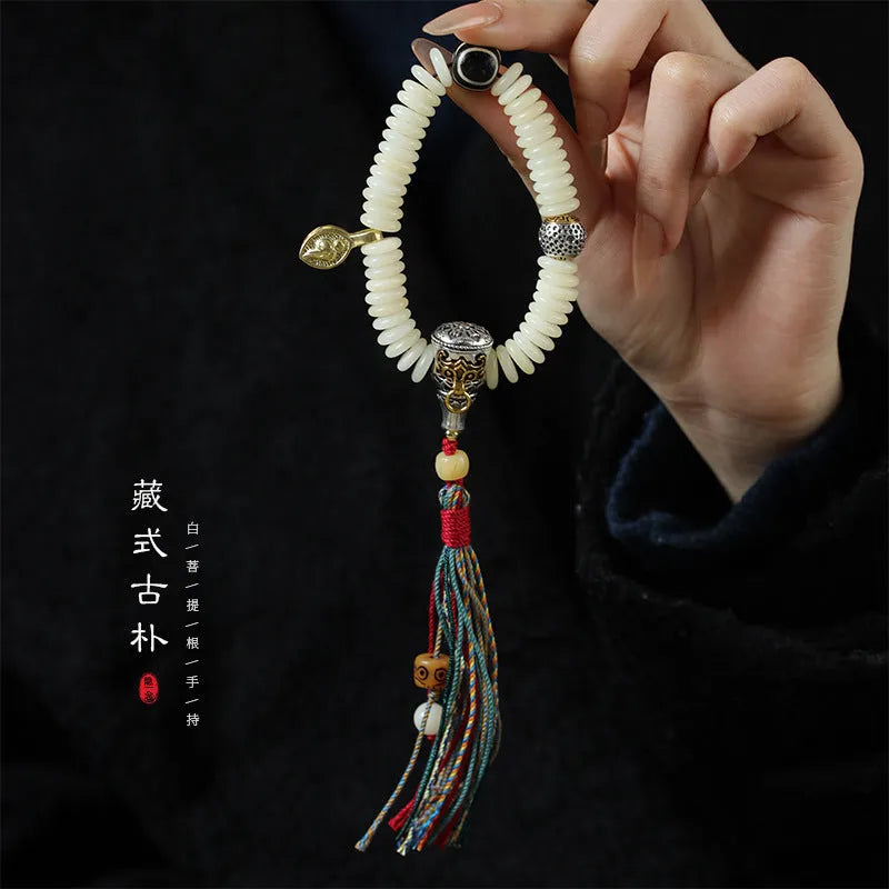 Close-up of a White Bodhi seed bracelet showing its 3x10mm beads and string.