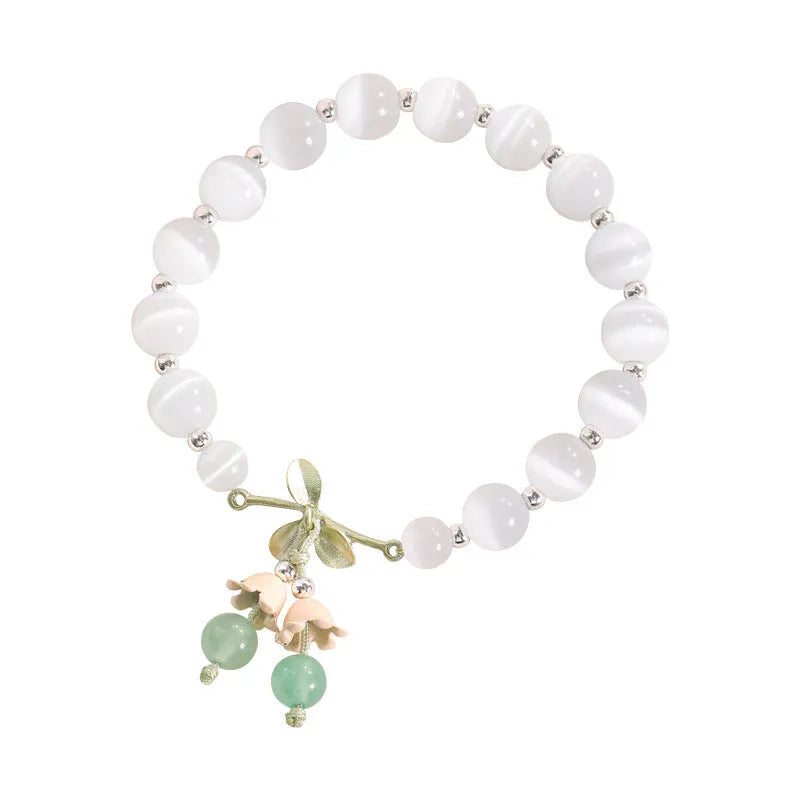 Close-up of electroplated opal cat's eye beaded bracelet for women with diamond-shaped charm
