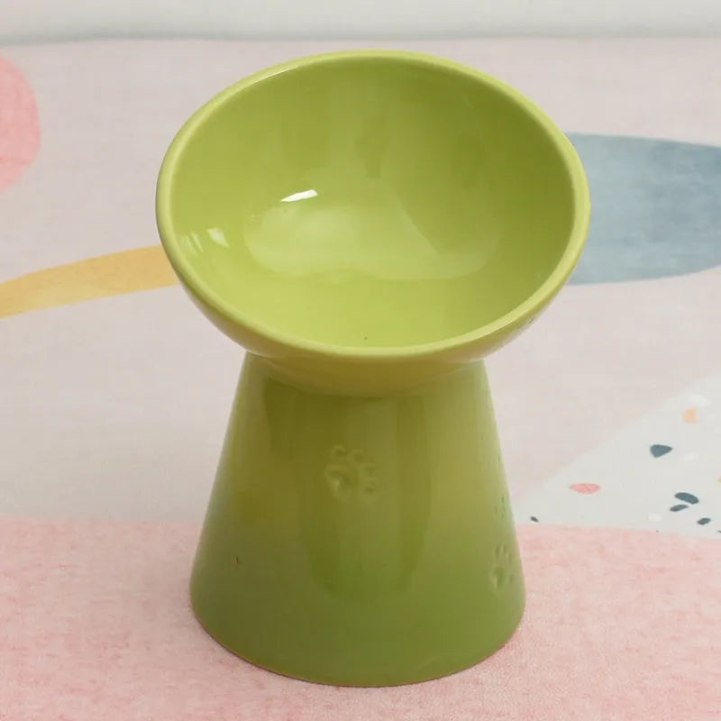 White ceramic pet bowl with a high foot base and wide, shallow eating area for dogs and cats