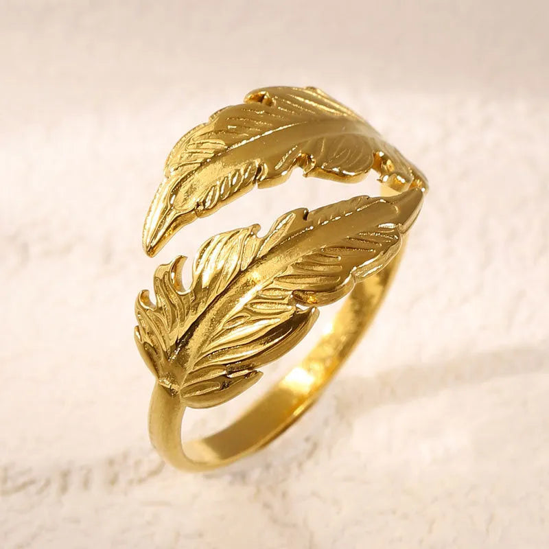 Women's stainless steel feather ring with adjustable opening in gold or silver finish