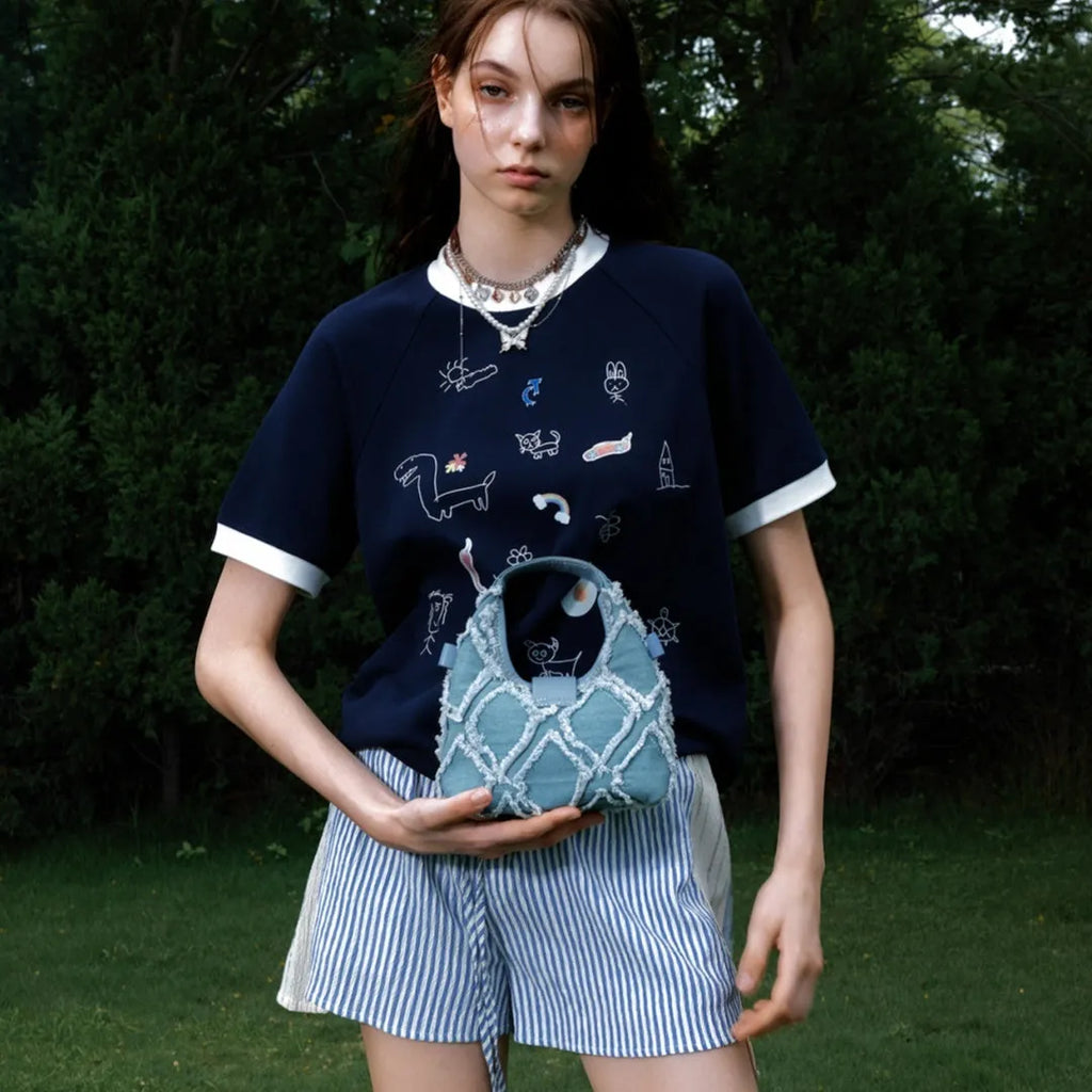 Men's blue and white loose fit short sleeve shirt with cartoon print and contrast colour details.